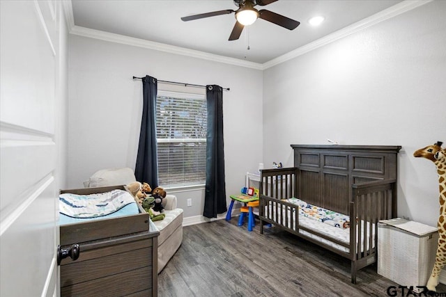 2609 Tulsa St, Tyler, TX 75702 - bedroom with wood finished floors, a nursery area, ornamental molding, and a ceiling fan