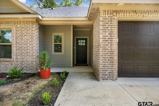 2609 Tulsa St, Tyler, TX 75702 - view of exterior entry with a garage and brick siding