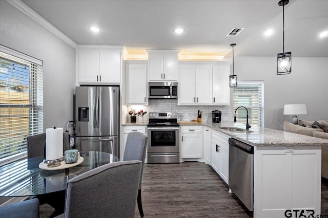 2609 Tulsa St, Tyler, TX 75702 - kitchen featuring appliances with stainless steel finishes, white cabinets, backsplash, dark wood finished floors, and light stone countertops