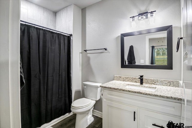 2609 Tulsa St, Tyler, TX 75702 - bathroom featuring vanity, wood finished floors, and shower / bathtub combination with curtain