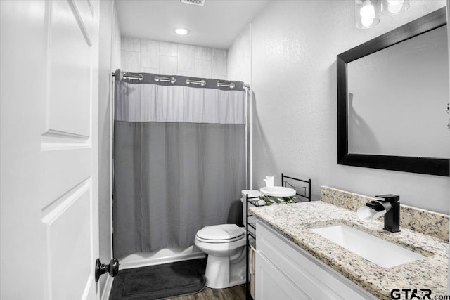 2609 Tulsa St, Tyler, TX 75702 - full bathroom with vanity, shower / tub combo with curtain, and wood finished floors