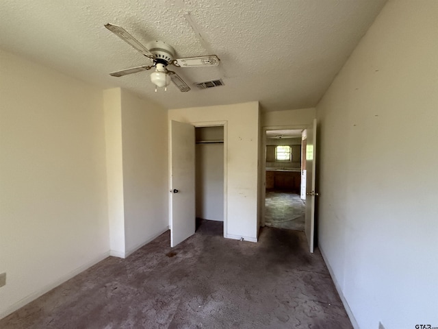 unfurnished bedroom featuring visible vents, a textured ceiling, a closet, and ceiling fan