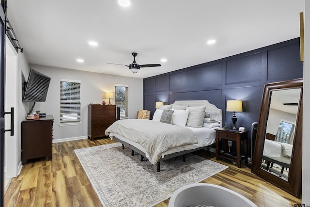 bedroom with wood-type flooring and ceiling fan