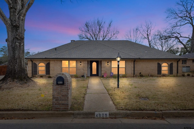 single story home with a yard