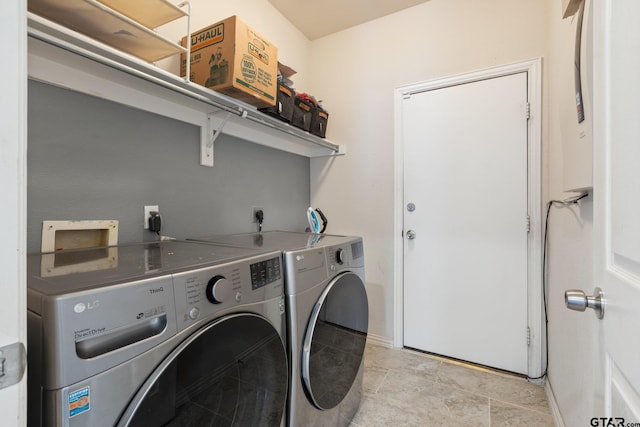 laundry room featuring baseboards, laundry area, and washing machine and dryer