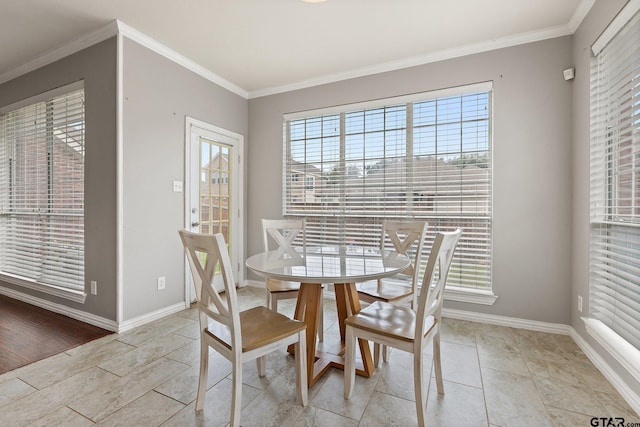 dining space with baseboards and ornamental molding