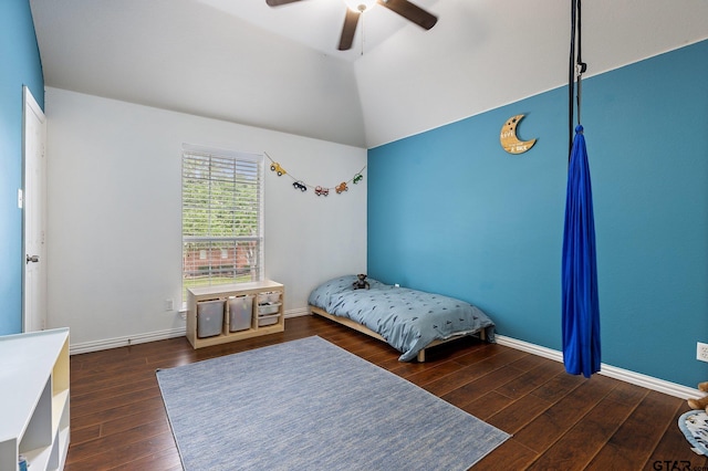 bedroom with baseboards, ceiling fan, wood finished floors, and vaulted ceiling