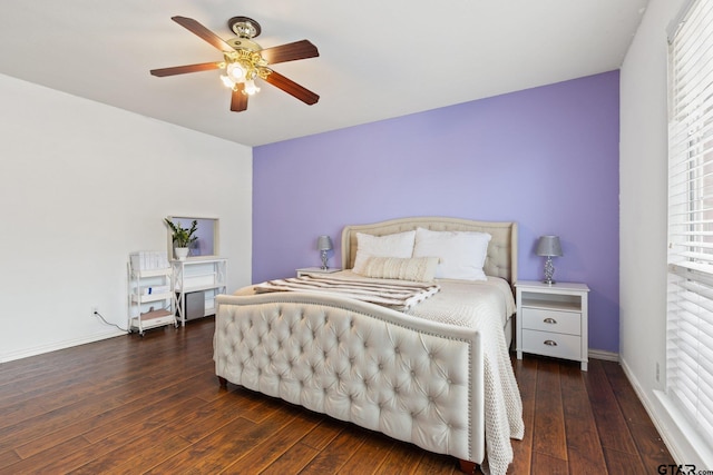 bedroom with wood-type flooring, a ceiling fan, and baseboards