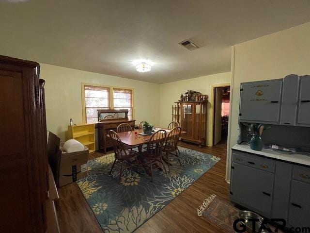 dining space featuring dark wood-type flooring