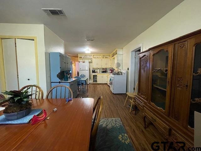 dining space with dark hardwood / wood-style flooring