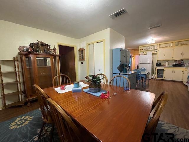 dining room featuring dark hardwood / wood-style floors and beverage cooler