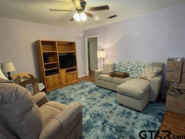 living room featuring ceiling fan and hardwood / wood-style floors