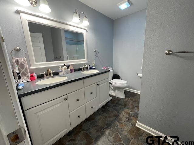 bathroom with vanity and toilet