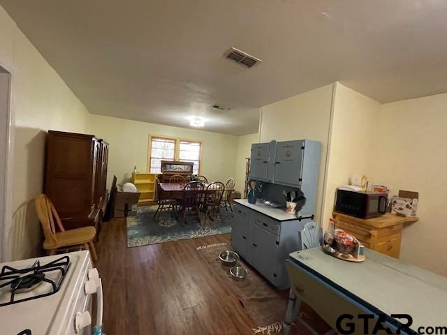 kitchen featuring white gas range and dark hardwood / wood-style flooring