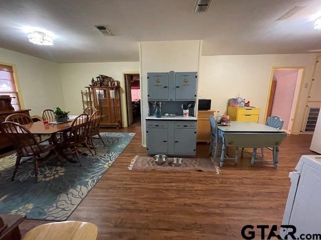 interior space with dark wood-type flooring and washer / dryer