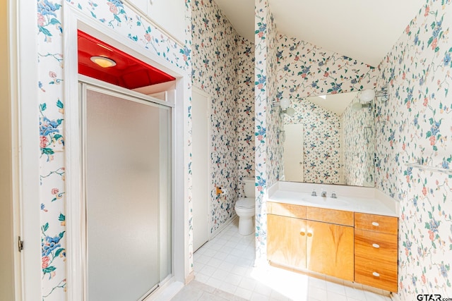 bathroom featuring toilet, tile patterned flooring, vanity, wallpapered walls, and a stall shower