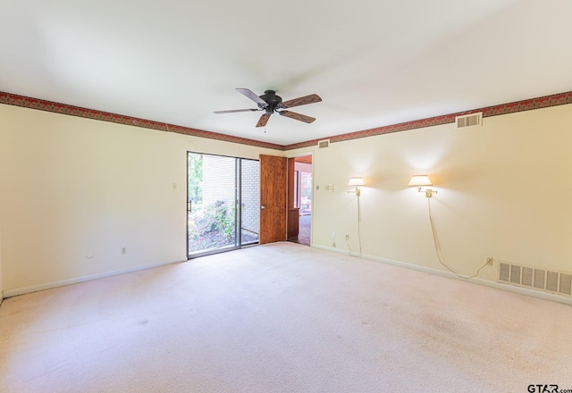 empty room with visible vents, baseboards, light colored carpet, and ceiling fan