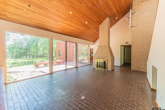 unfurnished living room with wood ceiling, high vaulted ceiling, visible vents, and brick patterned floor