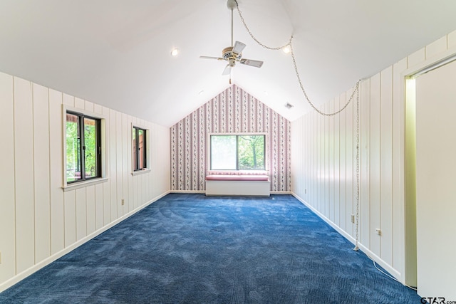additional living space featuring vaulted ceiling, a ceiling fan, carpet, and a wealth of natural light