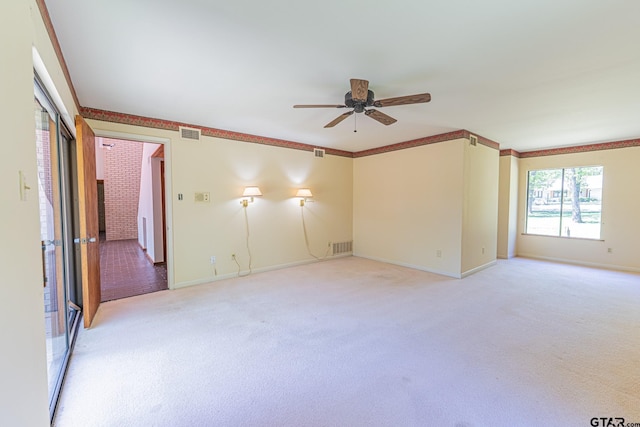 unfurnished room with baseboards, visible vents, light colored carpet, and a ceiling fan