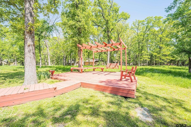 deck featuring a pergola and a lawn