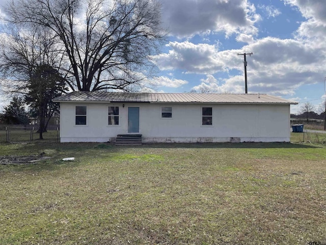 rear view of property with a yard