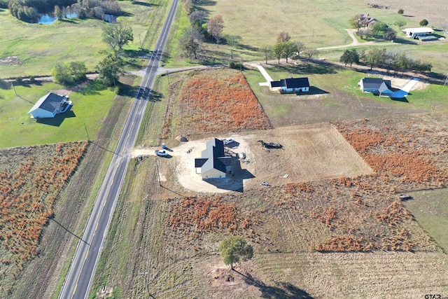 birds eye view of property with a rural view