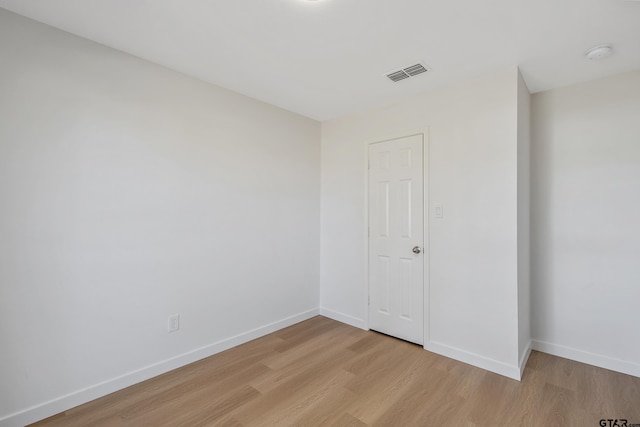 spare room with light hardwood / wood-style flooring