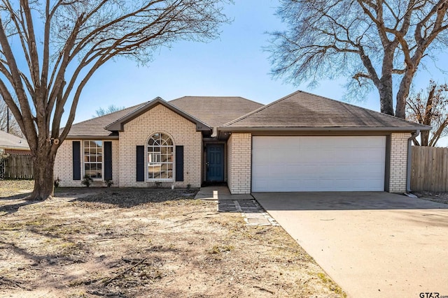 single story home featuring fence, roof with shingles, concrete driveway, an attached garage, and brick siding