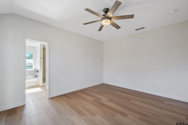 unfurnished room featuring ceiling fan, vaulted ceiling, and light wood-type flooring