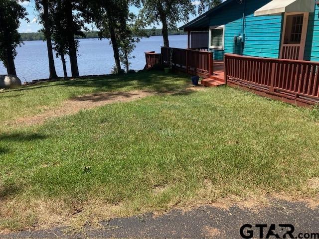 view of yard featuring a deck with water view