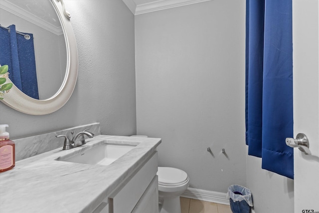 bathroom with tile patterned floors, crown molding, vanity, and toilet