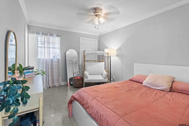 bedroom with ceiling fan, wood-type flooring, and ornamental molding