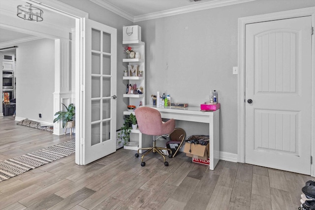 home office with ornamental molding, french doors, and light hardwood / wood-style flooring