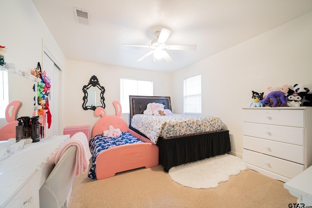 bedroom with ceiling fan and light carpet