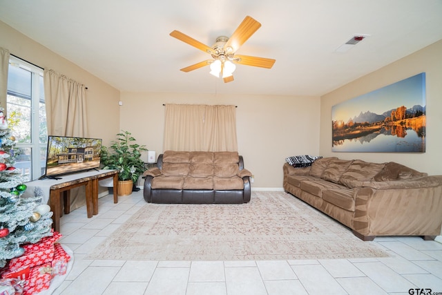 living room with ceiling fan and light tile patterned flooring