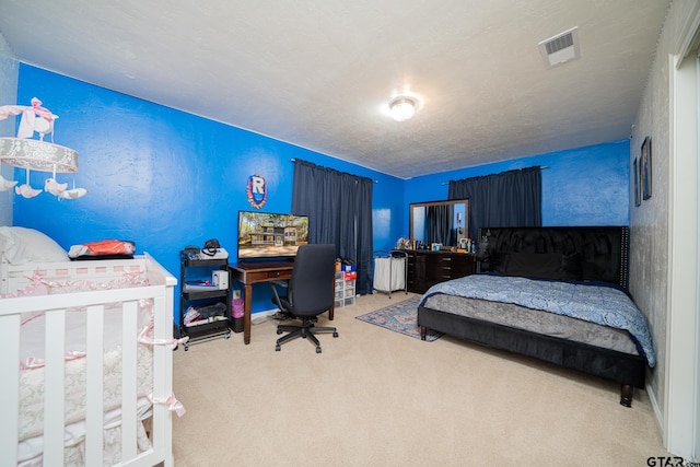 carpeted bedroom with a textured ceiling