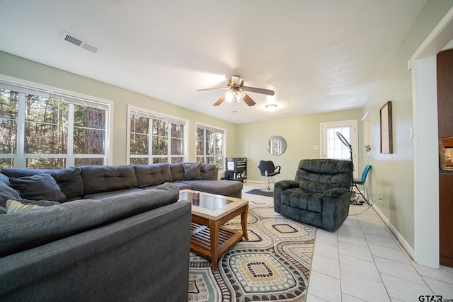 tiled living room with ceiling fan and a wealth of natural light