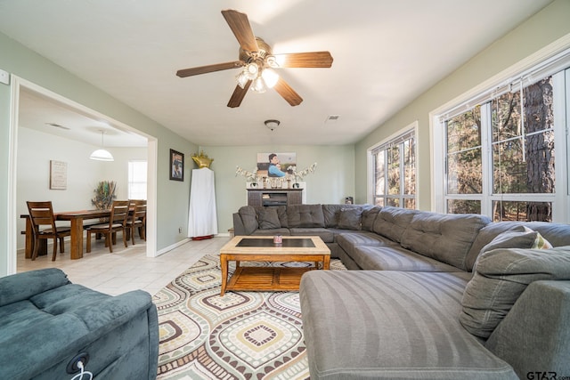 tiled living room featuring ceiling fan