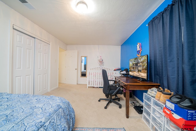 carpeted bedroom featuring a closet