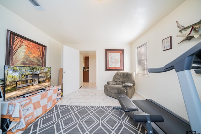 exercise room with light tile patterned floors