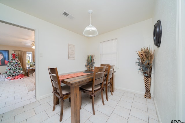 tiled dining area featuring ceiling fan