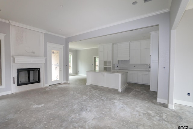 11941 Gillian Ct, Tyler, TX 75703 - kitchen with crown molding, white cabinets, a kitchen island, and open floor plan