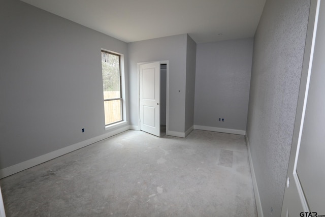 11941 Gillian Ct, Tyler, TX 75703 - empty room featuring baseboards and unfinished concrete flooring