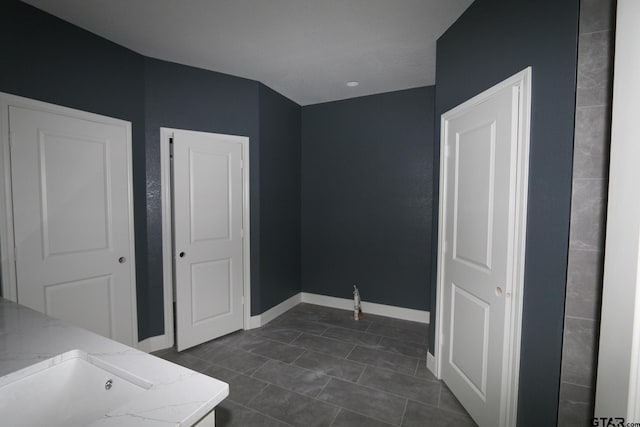 11941 Gillian Ct, Tyler, TX 75703 - bathroom with tile patterned flooring, a sink, and baseboards