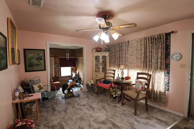 2391 Fm 16 W, Tyler, TX 75706 - living area with a ceiling fan and a textured ceiling