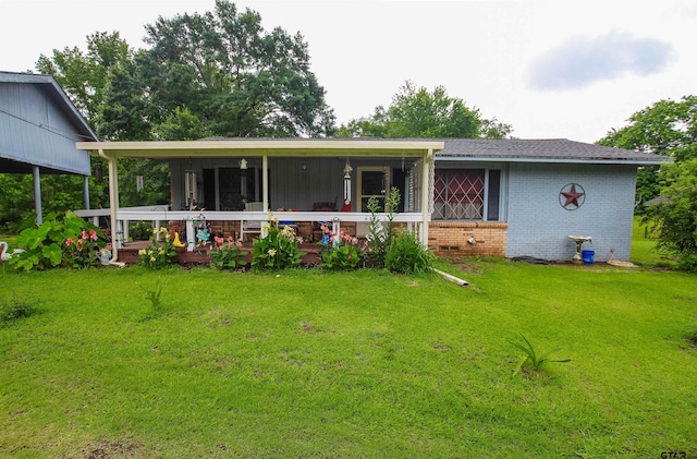 2391 Fm 16 W, Tyler, TX 75706 - view of front of property with brick siding, a front yard, and a sunroom