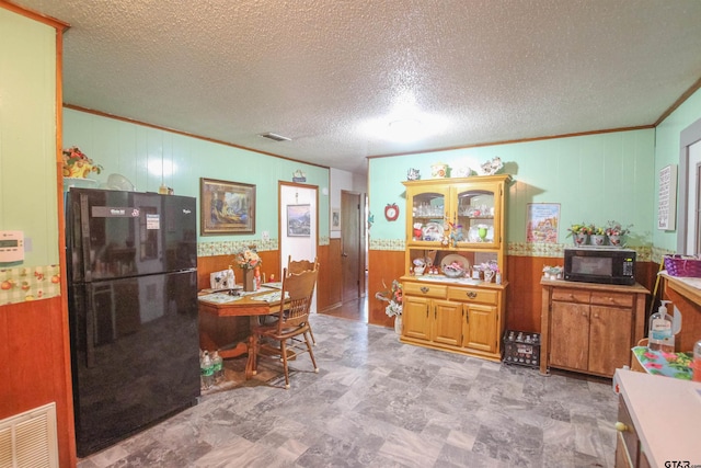 2391 Fm 16 W, Tyler, TX 75706 - dining room with crown molding, a textured ceiling, wooden walls, and a wainscoted wall