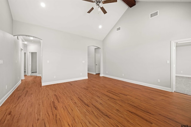 unfurnished living room with ceiling fan, beamed ceiling, light wood-type flooring, and high vaulted ceiling