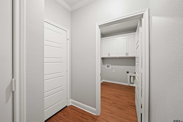 laundry area featuring hookup for an electric dryer, cabinets, hardwood / wood-style flooring, washer hookup, and crown molding